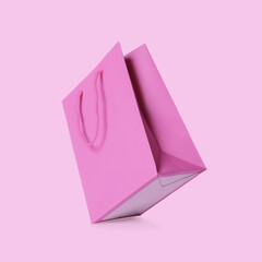 Shopping bag in air on pink background