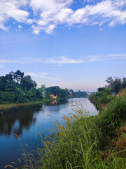 river within a village and greenery