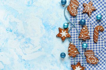 Christmas gingerbread cookies and balls on light blue background