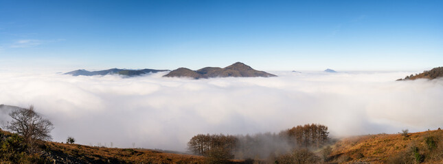 Amazing sea of clouds panorama above the mountains of the Basque Country. Spain.  - 730428962