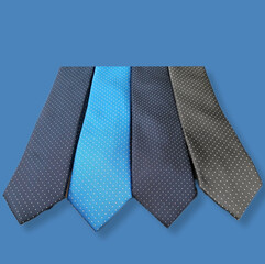 Ties in different colors with polka dot pattern on a light blue background