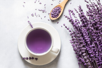 Cup of lavender tea with dried lavender flowers on rustic table, herbal relaxing tea. Lavendula oleum