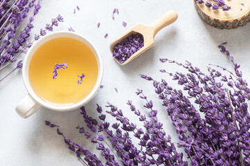 Cup of lavender tea with dried lavender flowers on rustic table, herbal relaxing tea. Lavendula oleum