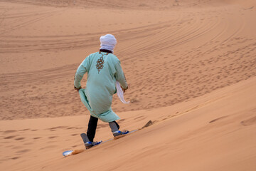 arab man doing sandboard - 730433304