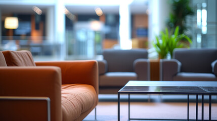 Simple, out-of-focus background of a business lounge with indistinct shapes of sofas and a coffee table.
