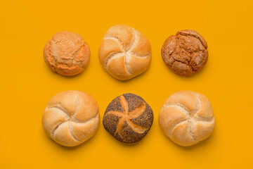 Different delicious buns on orange background