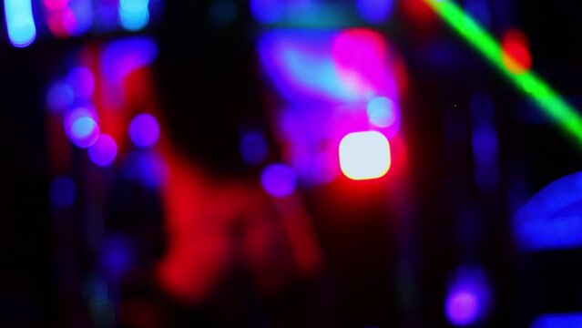 Naked stripper in stockings performs on stage of night club, soft focus