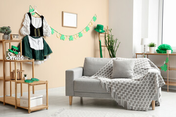 Interior of festive living room with grey sofa, waitress costume and garland. St. Patrick's Day...
