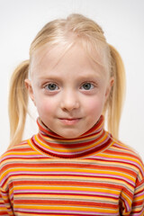 Naklejka premium Portrait of a little girl with blond hair on a white background