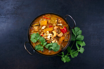 Traditional Indian vegetarian curry stew with sweet potatoes, paprika and eggplant served as top...