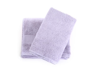 Folded violet terry towels isolated on white, top view