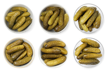 Tasty pickled cucumbers in bowls isolated on white, top view