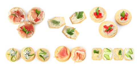 Delicious crackers with different toppings isolated on white, top view