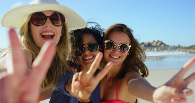 Face, women and smile with peace sign, beach and happiness with friends and seaside with weekend break. Memory, profile picture and vacation with girls or travel with getaway trip and tropical island