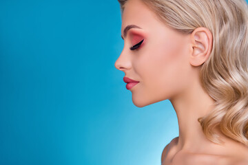 Fototapeta premium Profile side photo od lady in beauty salon treatment having her face make up over blue background