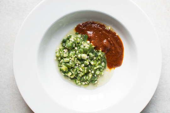 Nigerian okro and stew in a white plate, top view of okro soup