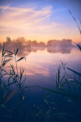 Calm lake at colorful sunrise. High quality photo - 730450137