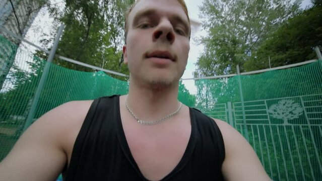 Young man face during jumping on trampoline. Slow motion