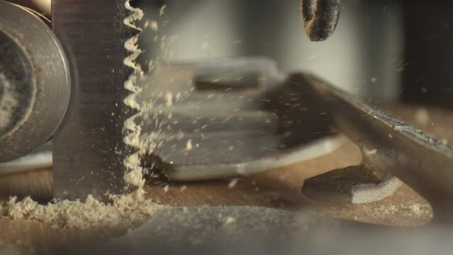 Slow motion 4k Video of a Jigsaw. closeup of wood chips flying away.