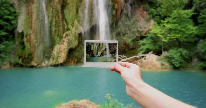 Person, hand and picture of waterfall in nature travel, landmark or vacation at angel falls in Venezuela. Closeup of traveler holding photograph of natural scenery, peaceful river or outdoor memory