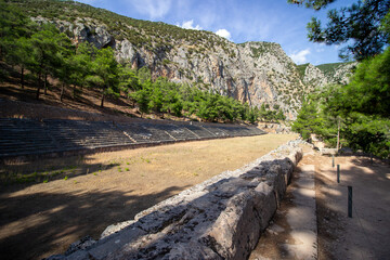 Fototapeta na wymiar The ancient stadium of Delphi is located at the highest point of the sanctuary of the Apollo archaeological site. One of the most important ancient Greek religious sanctuaries to the god Apollo. 