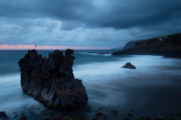 Serene seascape with dramatic rock formations at dusk in Tenerife Island