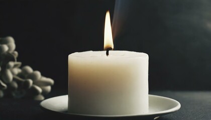 White burning candle on a black background	
