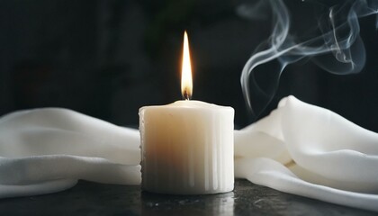 Fototapeta na wymiar White burning candle on a black background 