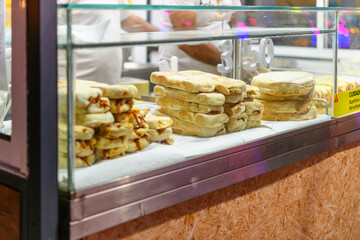 Close up view of a stack of Bolo do caco, a circular Madeiran flatbread, shaped like a cake and traditionally cooked on a caco, a flat basalt stone slab. Funchal, Portugal, Madeira Island.