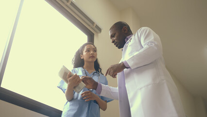 doctor is teaching with medical students on the way. - 730469530