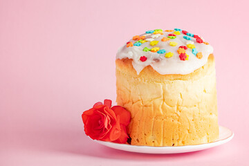 Delicious Easter cakes panettone decorated with ribbon and flowers on pink background.