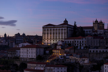Fototapeta na wymiar Panoramic view of Porto city at night with the Episcopal Palace (Paco Episcopal) of Porto in Portugal.