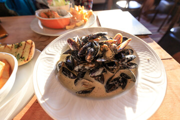 Sunlit Delight: A Plate of Creamy Mussels
