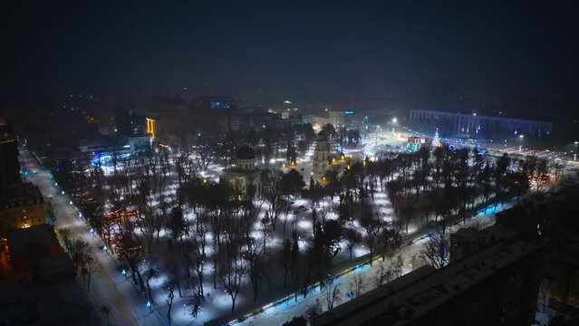 Aerial drone view of Chisinau center city covered in snow. Cathedral and Government building at night. Moldova