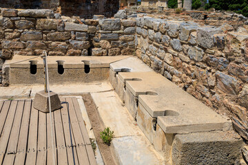 Antique Roman public toilet in the city of Ephesus. Background with selective focus and copy space