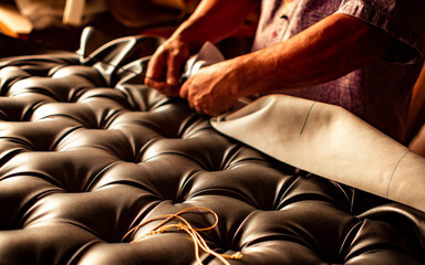 hands of an upholsterer working at his craft