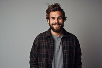 Portrait of a handsome young man with trendy hairstyle and beard