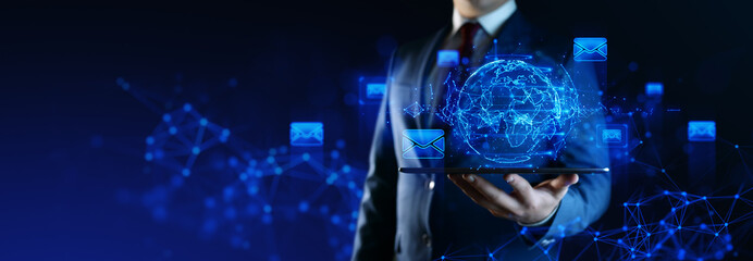 Businessman with Globe Hologram and icons: Message Email Mail Communication Online Chat Concept
