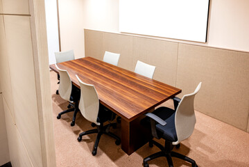 View of inside meeting room with table and office chairs