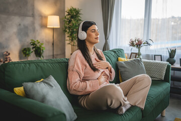 Fototapeta premium one woman doing guided meditation yoga self care practice at home
