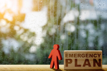 Wooden figure and wooden block with 'Emergency plan' text