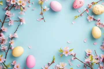 Fotobehang Minimalistic Easter background mockup with negative empty space for text. Easter eggs and spring sakura flowers on a blue background. Space for text, decor concept. Blank space in the middle © molokot