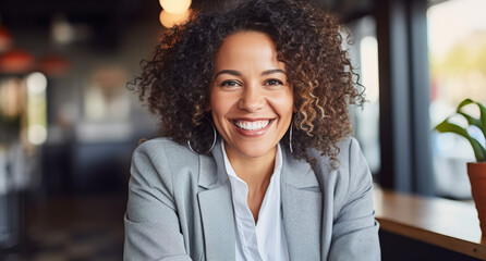 a smiling woman with a business jacket in an office