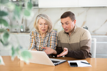 Male agent showing presentation and making offer to old woman