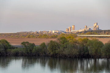 Industrial landscape near the river, large factory next to the river
