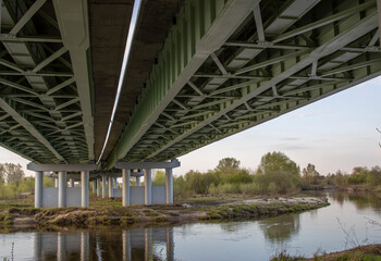 Construction of a road bridge across a river, a metal structure on reinforced concrete supports