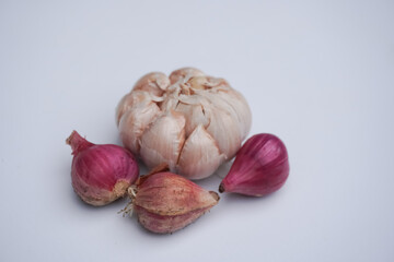 Garlic and shallot on white background. Shallow depth of field.