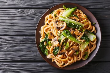 Top view of Asian vegetarian udon noodles with baby bok choy shiitake mushrooms sesame and pepper on a table - obrazy, fototapety, plakaty