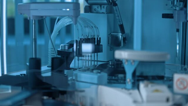 Close up of medical centrifugal machine with test tubes analyzing blood samples. Advanced research lab with modern equipment. Drug or vaccine development in professional biotechnology laboratory.