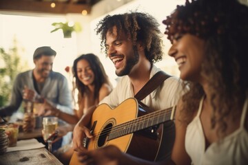 Man playing guitar with friends, enjoying a lively gathering